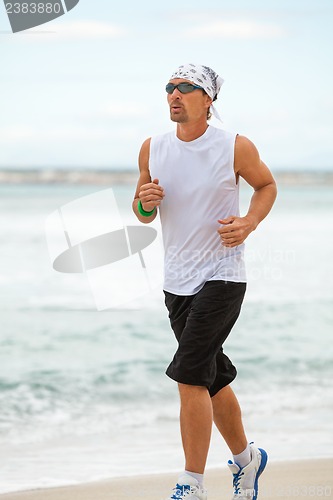 Image of man is jogging on the beach summertime sport fitness