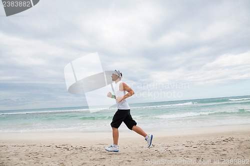 Image of man is jogging on the beach summertime sport fitness