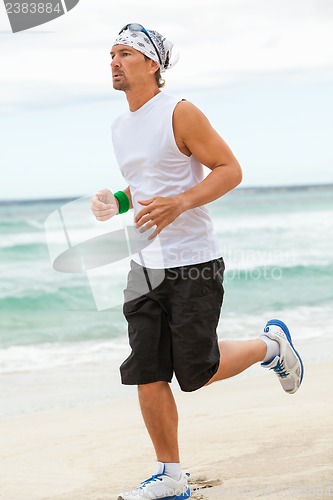 Image of man is jogging on the beach summertime sport fitness