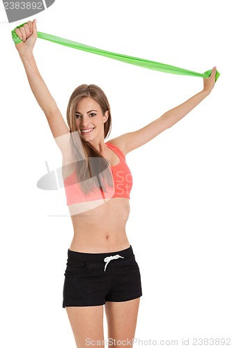 Image of athletic young woman doing workout with physio tape latex tape