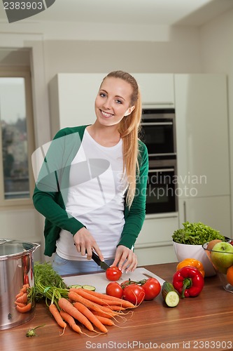 Image of young woman cooking vegetarian food