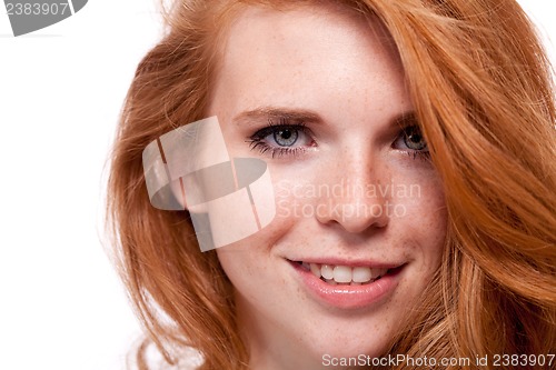 Image of beautiful young smiling woman with red hair and freckles isolated