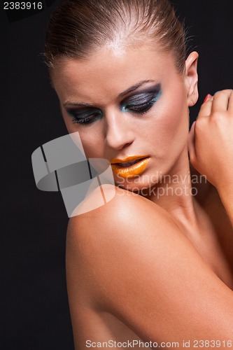 Image of woman with extreme colorfull make up in blue and yellow