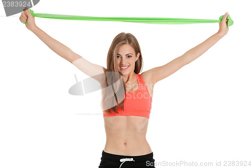 Image of athletic young woman doing workout with physio tape latex tape