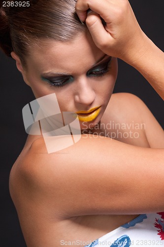 Image of woman with extreme colorfull make up in blue and yellow