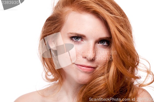 Image of beautiful young smiling woman with red hair and freckles isolated