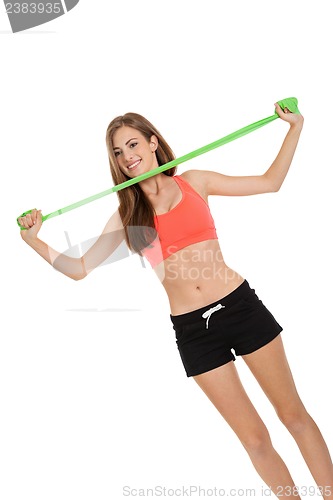 Image of athletic young woman doing workout with physio tape latex tape