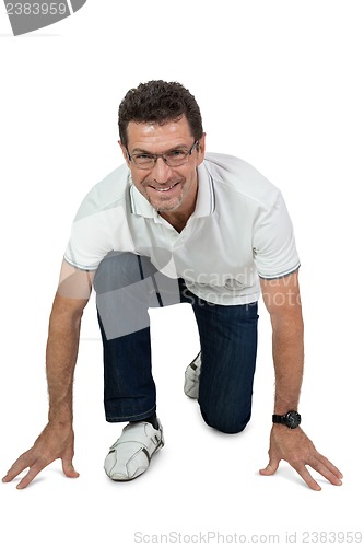 Image of attractive healthy adult man sitting on floor with jeans isolated