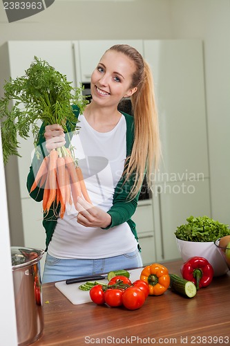 Image of young woman cooking vegetarian food