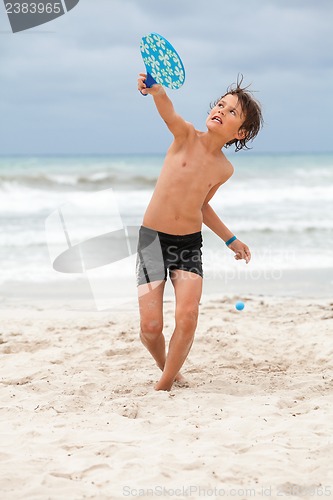 Image of happy little child kid boy  playing beachball on beach in summer 