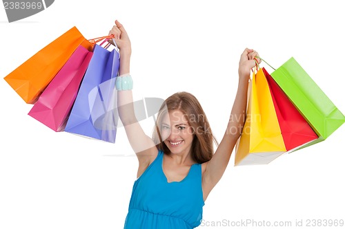 Image of attractive young woman with colorful shopping bags isolated