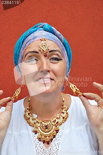 Image of playful blond senior woman with Indian jewleries