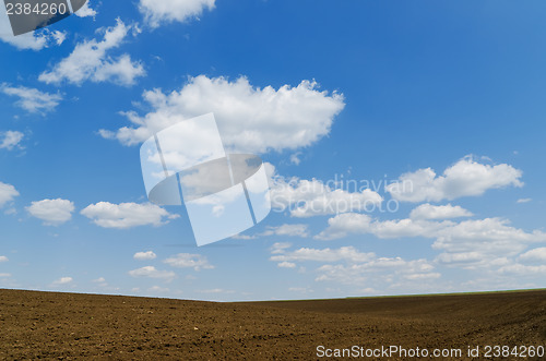 Image of cloudy sky over black field