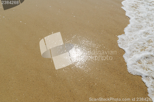 Image of sun reflection in sand on the beach