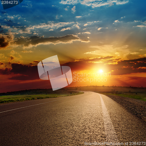 Image of beautiful sunset over asphalt road