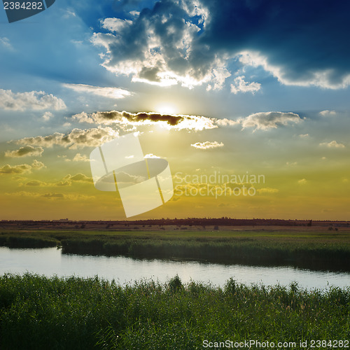 Image of cloudy sunset over river