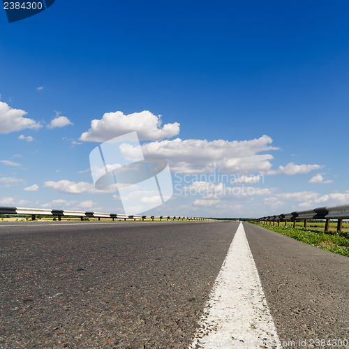 Image of road closeup under blue sky