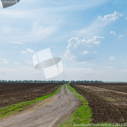 Image of country road to horizon in cloudy sky