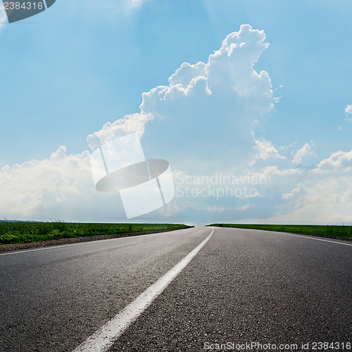 Image of asphalt road to horizon under cloudy sky