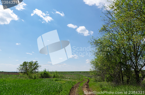 Image of winding rural road to horizon under cloudy sky