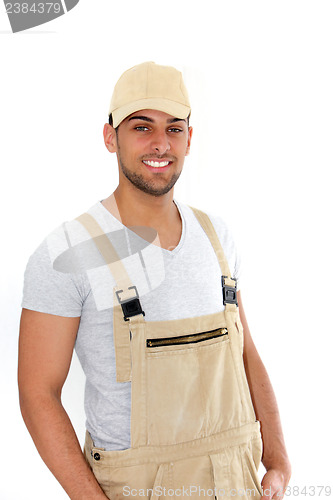 Image of Handsome man in cap and dungarees