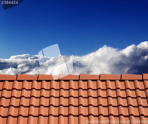 Image of Roof tiles and sunny sky with clouds