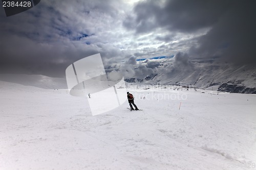 Image of Skiers on ski slope before storm