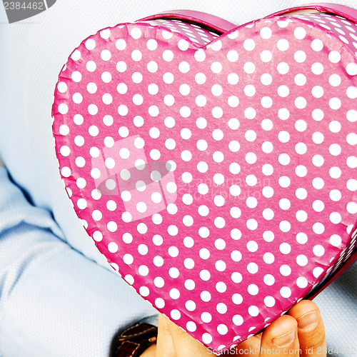 Image of Businessman hiding a gift