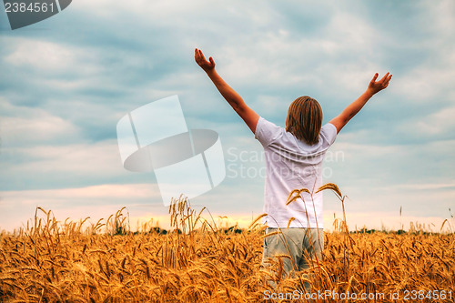 Image of Young man staying with raised hands