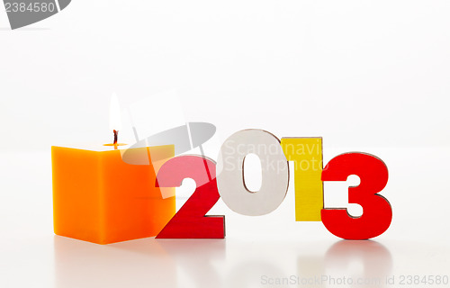 Image of Wooden 2013 year number with a burning candle