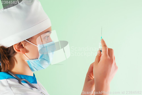 Image of Young lady doctor with syringe