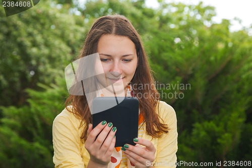 Image of Teen girl reading electronic book