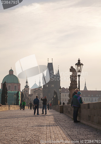 Image of Charles bridge early in the morning with tourists