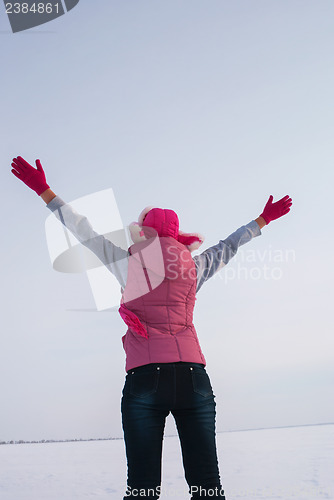 Image of Teen girl staying with raised hands