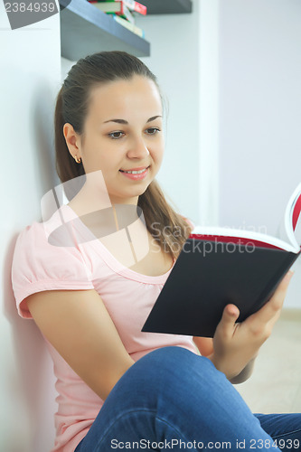 Image of Young attractive lady with a book