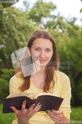 Image of Teen girl reading book