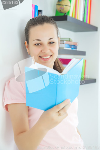 Image of Young attractive lady with a book