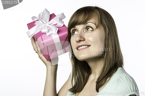 Image of young girl listens to a gift