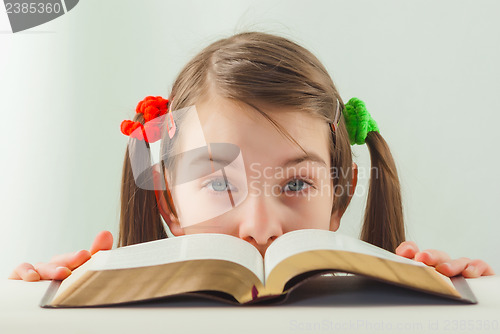 Image of Surprised teen girl with the Bible