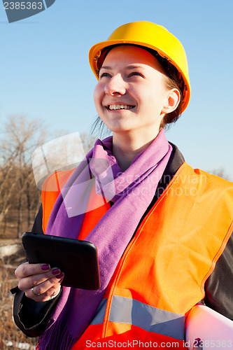 Image of Young lady architect staying outdoors