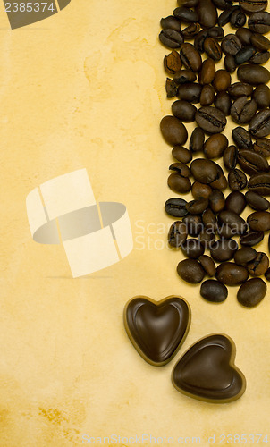 Image of Two heart shaped chocolate candies and coffee beans