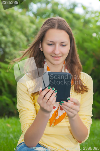 Image of Teen girl reading electronic book