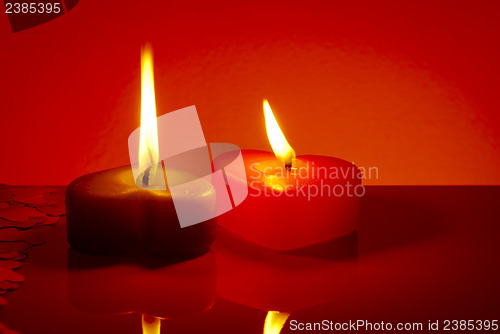 Image of Two burning heart shaped candles