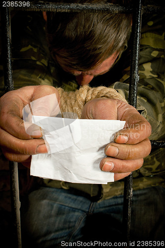 Image of Man with hands tied up with rope