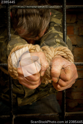 Image of Man with hands tied with rope