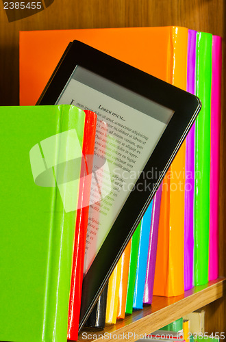 Image of Row of colorful books and electronic book reader