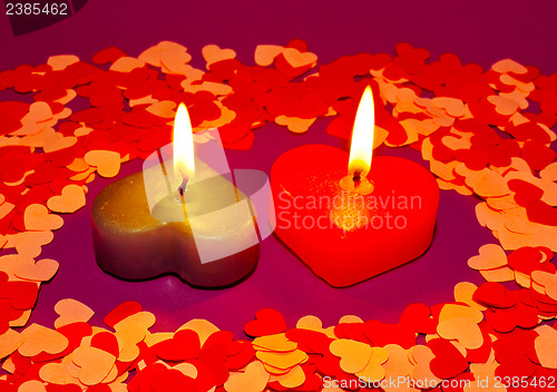 Image of Two burning heart shaped candles