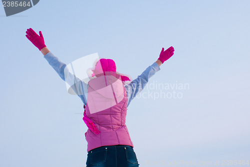 Image of Teen girl staying with raised hands