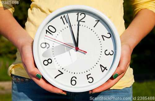 Image of Female holds watches