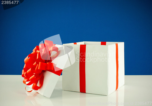 Image of White box with present against blue background